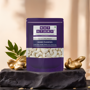 Purple package of Nut Story Jumbo Cashews on a dark surface with decorative elements.